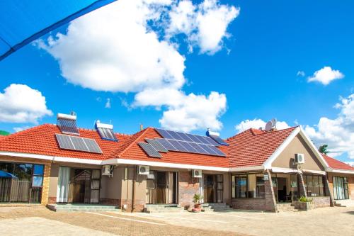 a house with solar panels on the roof at Standard room in Morningside guesthouse - 2090 in Bulawayo