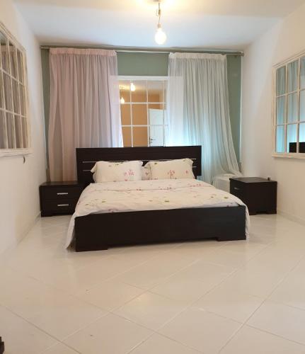 a bedroom with a large bed in a room at HOUSE SUITES DOMAINE in Rizómilos