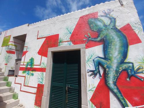 a painting of a lizard on the side of a building at Meraki Hostel in Sintra