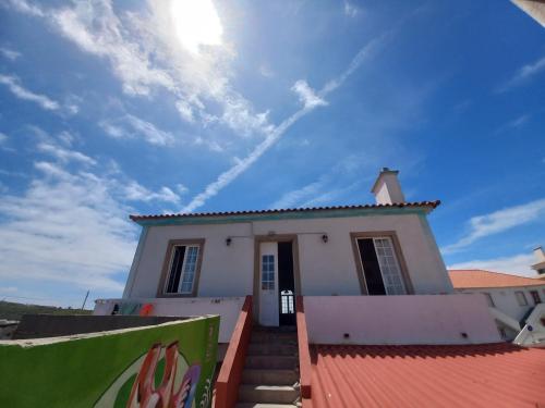 a small white house with a red roof at Meraki Hostel in Sintra
