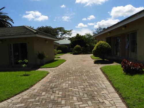 a brick driveway in front of a house at 2 bedroomed apartment with en-suite and kitchenette - 2071 in Harare
