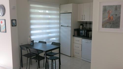 a kitchen with a table and chairs and a refrigerator at Summer House by the Sea - 40 m to the beach in Side