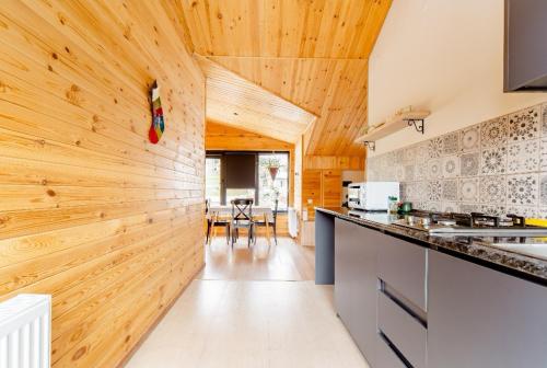 a kitchen with wooden walls and a counter top at Aronia Kazbegi in Stepantsminda