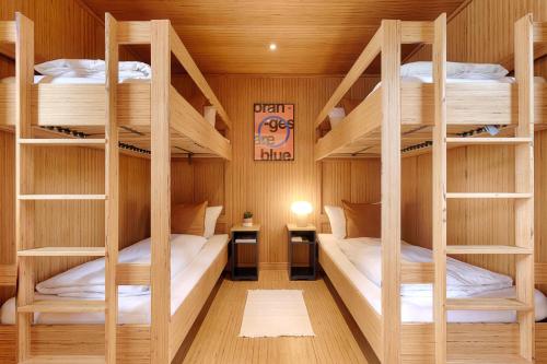 a bunk room with three bunk beds in it at Radapartment -Terrasse & Grill - by homekeepers in Iphofen