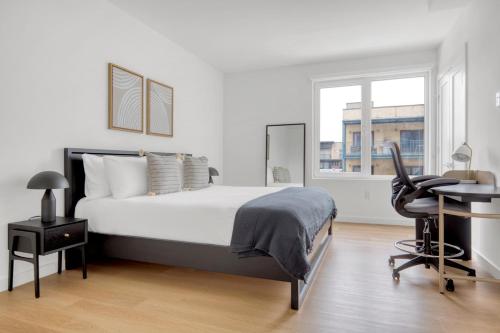 a bedroom with a bed and a desk and a chair at Hoboken 1BR w Elevator Gym Terrace Courtyard NYC-790 in Hoboken
