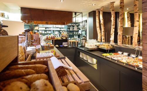 a bakery with a counter with different types of bread at AvenidA Mountain Lodges Saalbach in Saalbach Hinterglemm