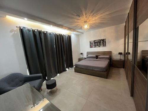 a bedroom with a bed and black curtains in it at Stunning penthouse, 2 bedroom, heart of Sliema in Sliema