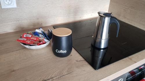 a coffee pot on a counter next to a bowl of chips at Posnania Comfort Apartment, free parking, self check-in 24h in Poznań