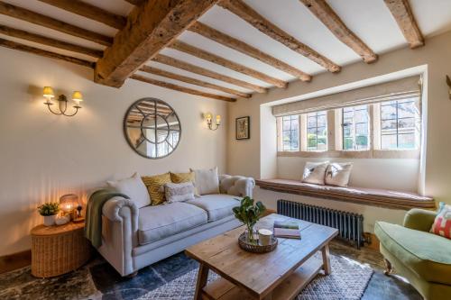 a living room with a couch and a table at Stone Cottage in Stanton