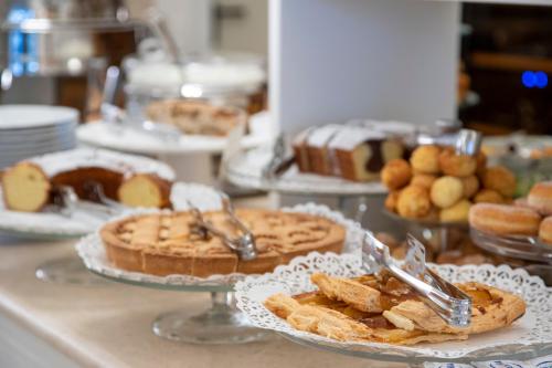 a buffet of pies and pastries on a counter at Hotel Olimpia in Forte dei Marmi