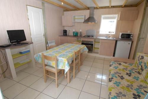 a kitchen with a table and chairs in a room at Gîte le Fouquet in Cilaos