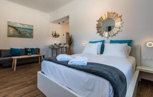 a bedroom with a large bed and a mirror at Island Dreams in Adamas