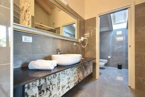 a bathroom with a sink and a mirror at Royal Garden luxury rooms in Padova