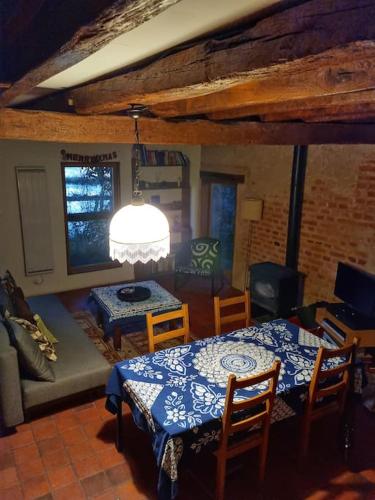 a living room with two tables and a couch at Tranquillitude au Moulin Bouquet in La Chapelle-aux-Chasses