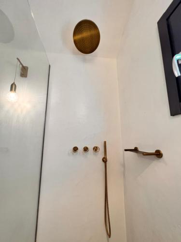 a shower stall in a bathroom with a glass door at LF Suites & Villas in Imerovigli