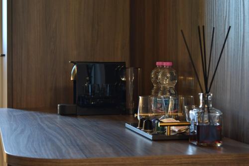 a table with a bottle and a television on it at Royal Garden luxury rooms in Padova