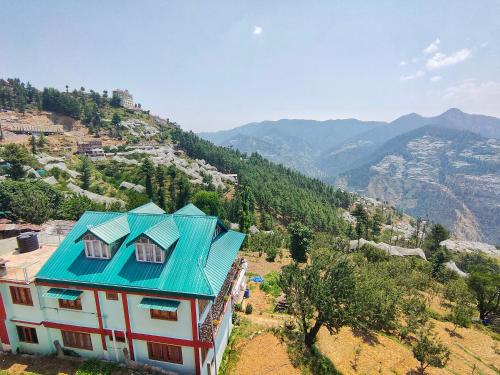 an overhead view of a house with a blue roof at Alpine Valley Homestay in Shimla