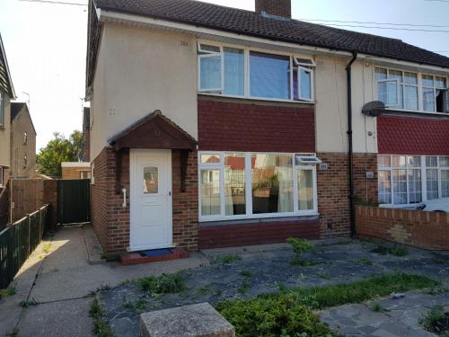 a brick house with a white door at 33SM Dreams Unlimited Serviced Accommodation- Staines - Heathrow in Stanwell