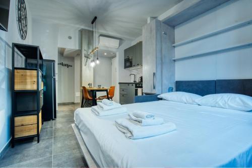 a bedroom with a large white bed with towels on it at Italianflat - Angolino dei navigli in Milan