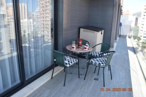 a small table and chairs on a balcony at Sea view and Ifach Calpe in Calpe