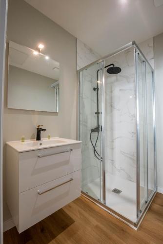 a white bathroom with a shower and a sink at WelcomeAgen*Charlie Chaplin in Agen