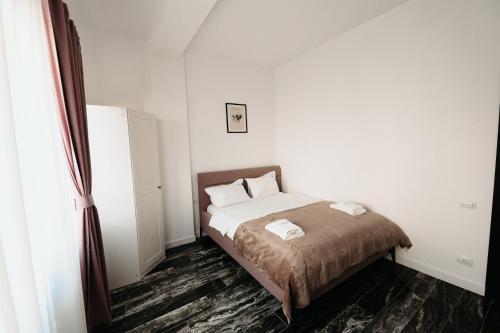 a bedroom with a bed with two pillows on it at Cozy Aparthotel - Central City Suceava in Suceava
