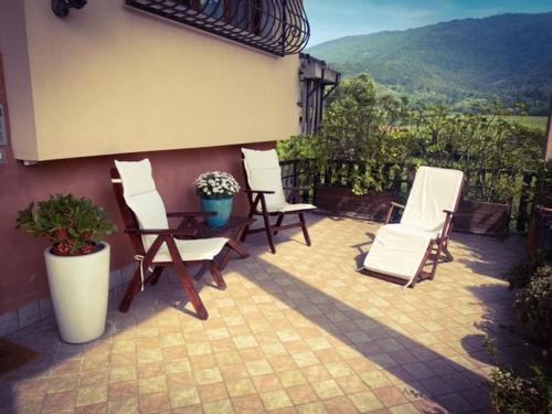 a patio with chairs and a table with a view at La Valle B&B in Brescia