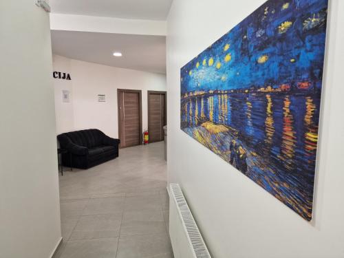 a hallway with a large painting on the wall at Vurk INN Paracin in Paraćin