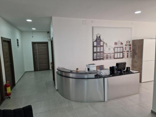 a lobby with a reception desk with a picture on the wall at Vurk INN Paracin in Paraćin