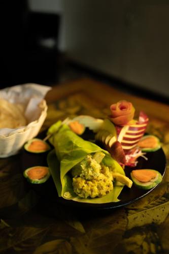 a black plate of food on a table at Parakkat Nature Resort in Munnar