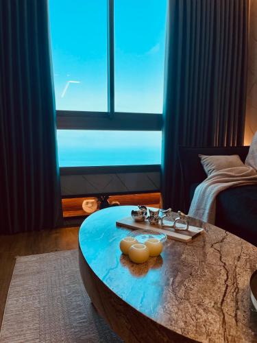 a living room with a table with food on it at C Tower Premium Apartments, Panoramic Sea View in Netanya