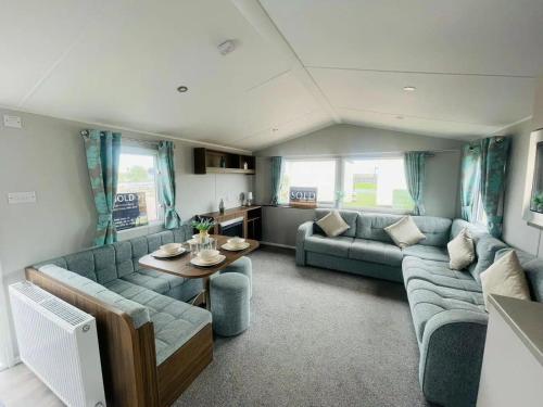 a living room with a couch and a table at Community Wishes Retreat - Butlins Passes Included in Lincolnshire