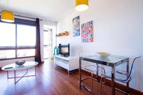 a living room with a table and a television at Castilla Luz Deco in Madrid