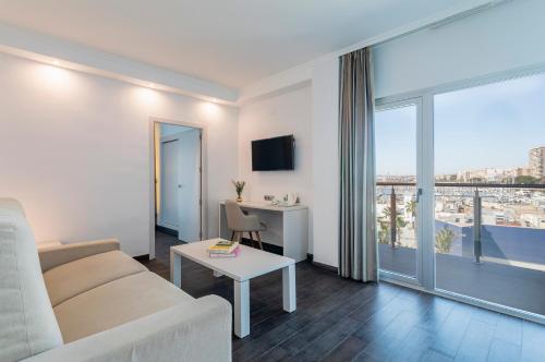 un soggiorno con divano e tavolo di Hotel Spa Porta Maris by Melia ad Alicante