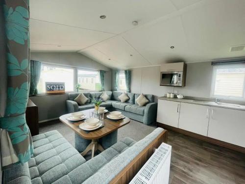 a living room with a couch and a table at Community Wishes Retreat - Butlins Passes Included in Lincolnshire