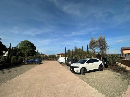 a row of cars parked in a parking lot at Hotel Palazzo San Lorenzo & Spa in Colle Val D'Elsa