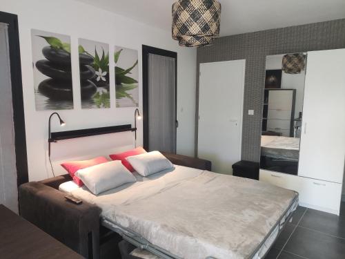 um quarto com uma cama grande e almofadas vermelhas e brancas em Villa Maya Blanca weekly rate 25 per cent em Lorgues