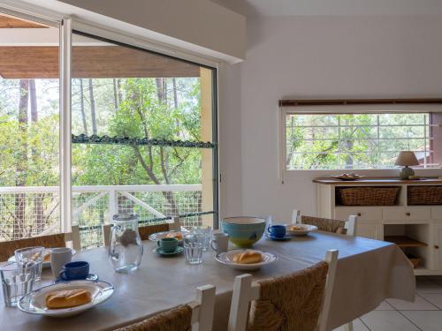 a dining room with a table with food on it at Holiday Home Golf Loisirs-4 by Interhome in Lacanau-Océan