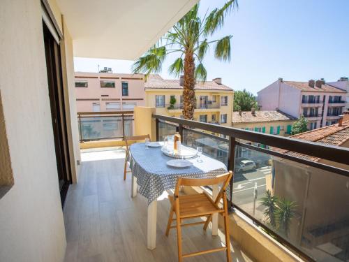 a balcony with a table and chairs on a balcony at Apartment Saint James-9 by Interhome in Le Lavandou