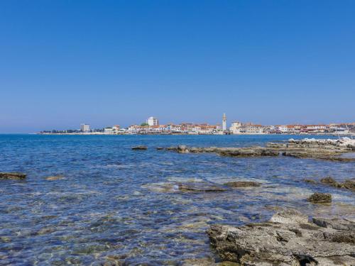 a body of water with a city in the background at Holiday Home Aron by Interhome in Umag