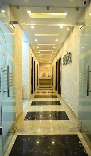 a hallway of a building with a tile floor at Hotel O Glance Inn in Patna