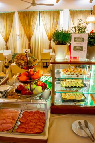 a buffet with many different types of food on display at eco Hotel Milano & BioRiso Restaurant in Milan