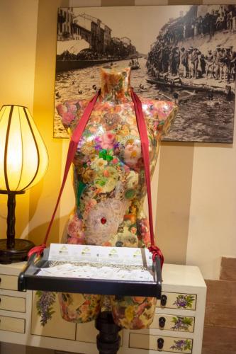 a dress on a stand next to a lamp at eco Hotel Milano & BioRiso Restaurant in Milan
