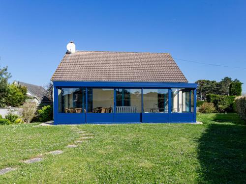 a blue house with a roof on a lawn at Holiday Home Colibri by Interhome in Saint-Germain-sur-Ay