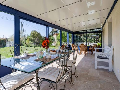 a dining room with a glass table and chairs at Holiday Home Colibri by Interhome in Saint-Germain-sur-Ay