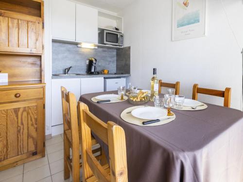 a table in a kitchen with a table cloth on it at Apartment Les Capitelles by Interhome in Saint-Cyprien-Plage