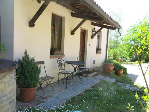 a patio with chairs and a table in front of a house at Holiday Home I Grilli by Interhome in Castagnole Lanze