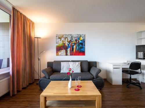 a living room with a couch and a table at Apartment B905 by Interhome in Lahnstein