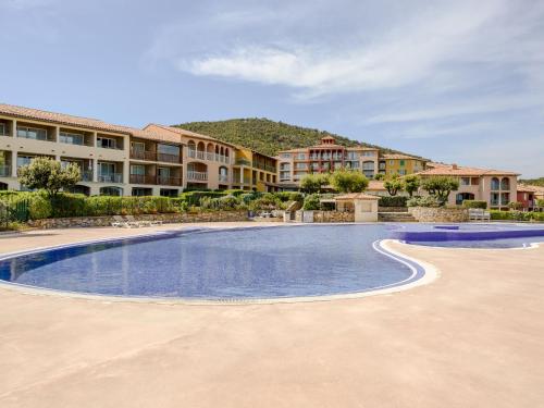 a swimming pool in front of a resort at Apartment Le Hameau des Issambres-5 by Interhome in Les Issambres