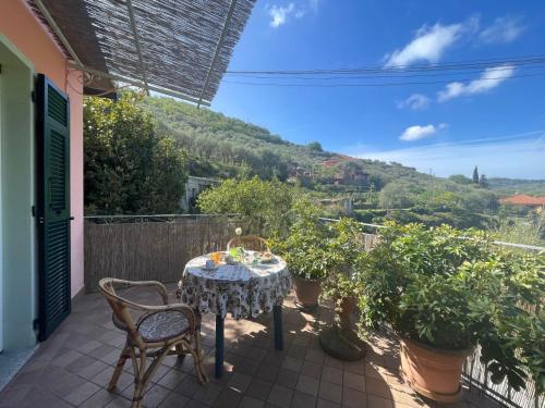 een tafel en stoelen op een patio met uitzicht bij Holiday Home Casa dei Nonni - IMP425 by Interhome in Imperia